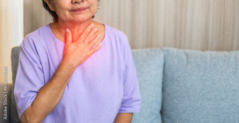 Sick senior women touching neck unwell coughing with sore throat pain