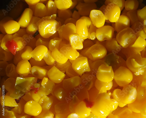 close up of cooked corn niblets with red and green pepper bits photo