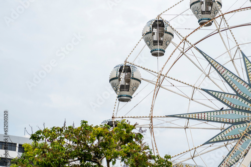 Fototapeta Naklejka Na Ścianę i Meble -  A Ferris wheel is an amusement ride consisting of a rotating upright wheel with multiple passenger-carrying components attached to the rim.