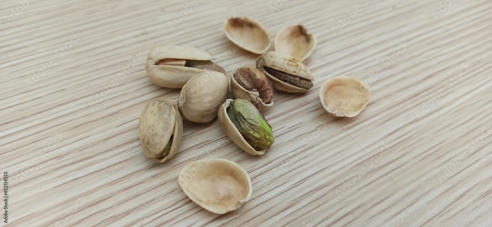 Pistachios on a wood texture background. Isolate.
