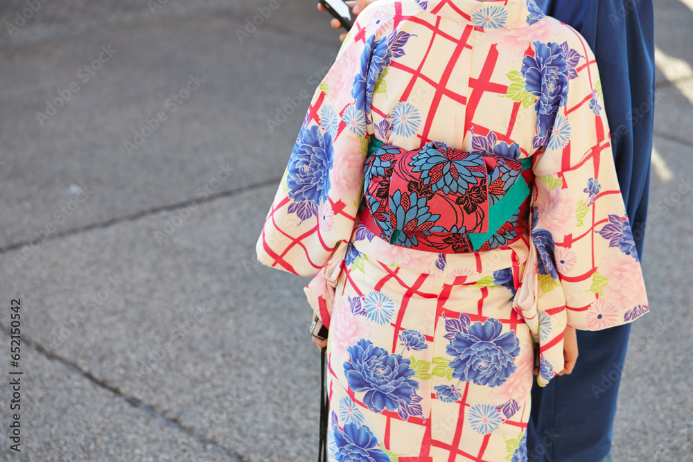 Back view of woman wearing yukata at temple