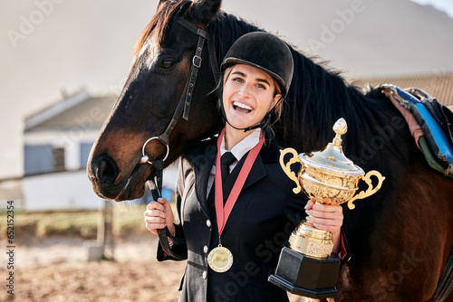 Portrait, equestrian and prize horse with a woman on a ranch for sports, training or a leisure hobby. Winner, trophy or award and a happy young rider in uniform with her stallion or mare outdoor