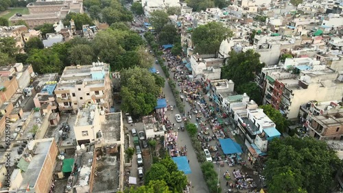 4K Aerial Shots of a Local market in New Delhi Residential Suburbs on a beautiful day gliding over Rooftops, streets, parks and markets in India photo