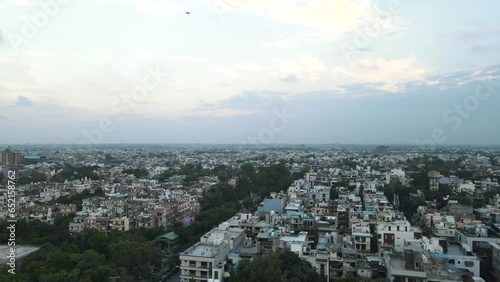 4K Aerial Shots of New Delhi Residential Suburbs on a beautiful day gliding over Rooftops, streets, parks and markets in India photo