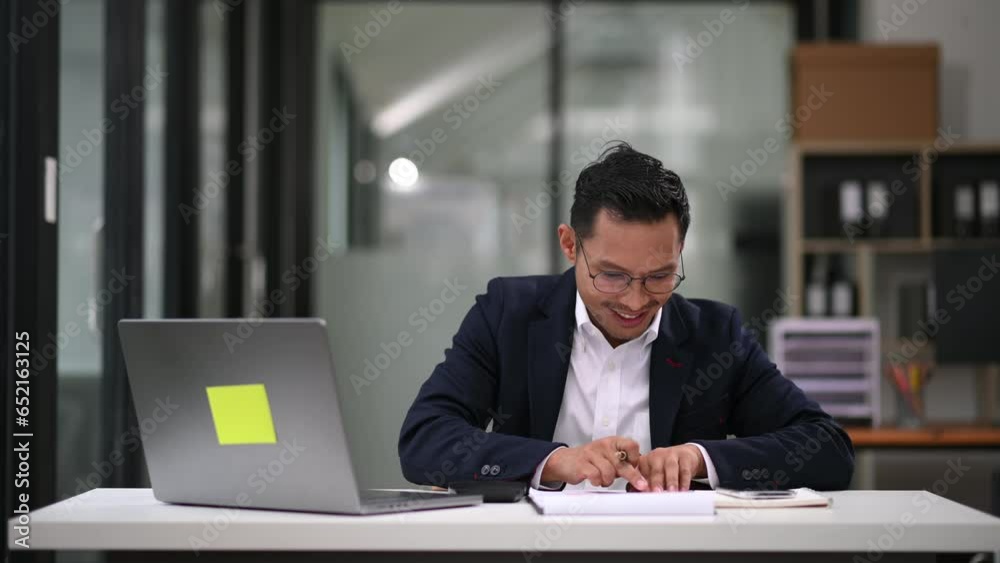 Business man executive manager looking at laptop watching online webinar training or having virtual meeting video conference doing market research working in office... Business man executive manager looking at laptop watching online webinar training or having virtual meeting video conference doing market research working in office...