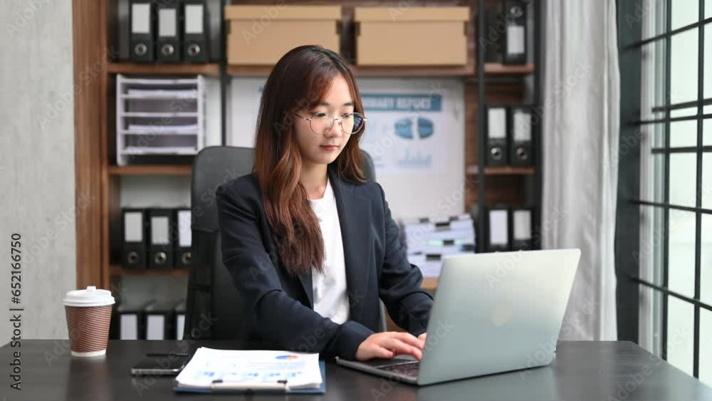Asian Business woman using tablet and laptop for doing math finance on an office desk, tax, report, accounting, statistics, and analytical research concept in office.. Asian Business woman using tablet and laptop for doing math finance on an office desk, tax, report, accounting, statistics, and analytical research concept in office..