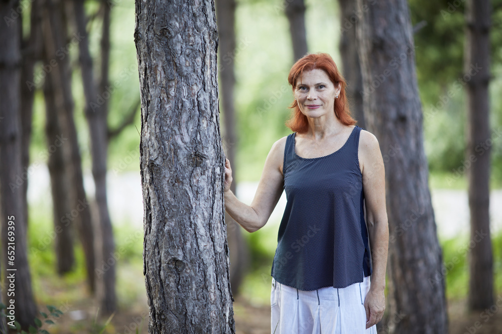 portrait of smiling senior woman in the forest