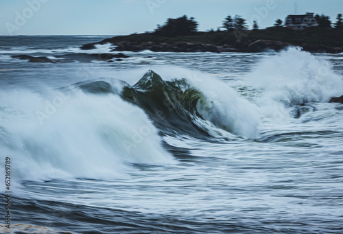 large atlantic ocean wave breaks along the Maine coast during storm
