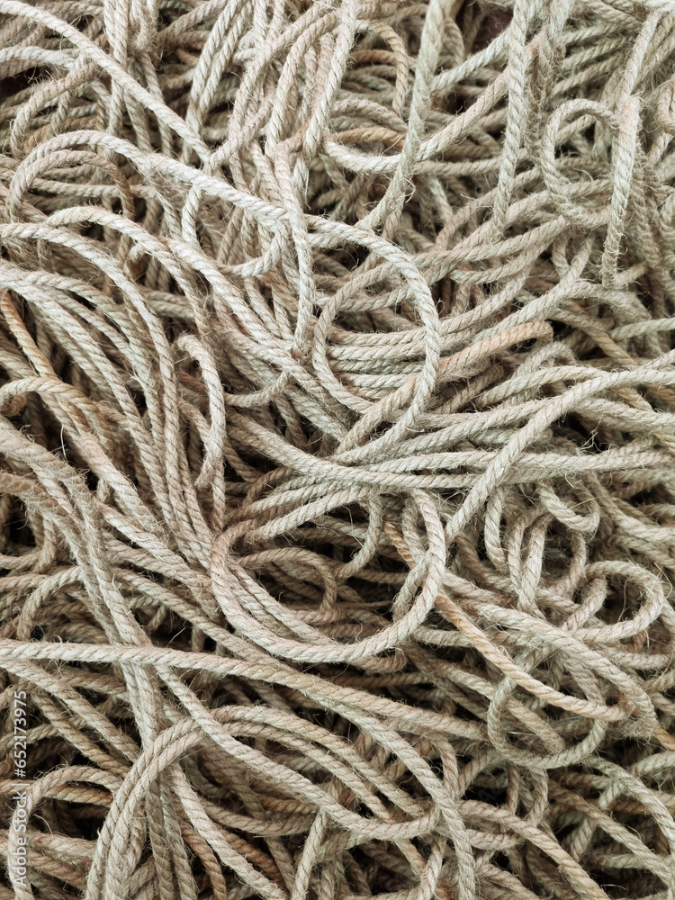 Tangled coarse linen ropes. Texture for the background. Selective focus