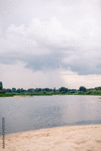 Landscape with sandy river bank and dramatic sky, copy space, natural background photo