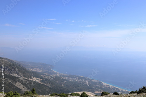 View on Dhermi from the famous SH8 road at the Llogara Pass in Albania - a high mountain pass within the Ceraunian Mountains along the Albanian Riviera. Tourist attraction. 