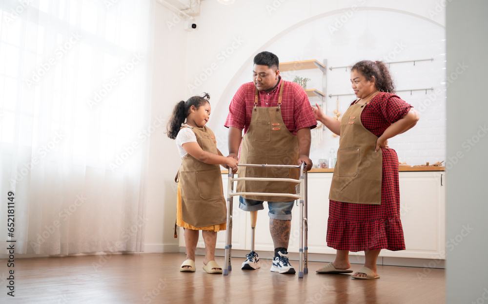 A plus-size family with a father wearing a prosthetic leg, Daughter helps father walk with walker in the kitchen room of the house