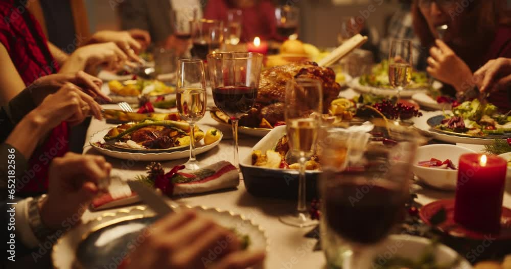 Guests Spending Leisure Time at Home During Holidays, Enjoying a Tasty Turkey Feast Behind a Dining Table. Close Up on an Adult Man Enjoying a Celebratory Dish, Cutting Turkey Meat on a Plate