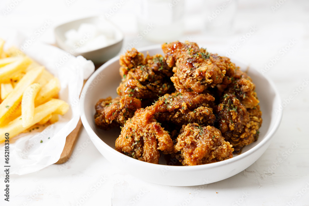 Fried chicken with soy sauce in Korean style with pickled radish. Fried chicken with soy sauce in Korean style with pickled radish.