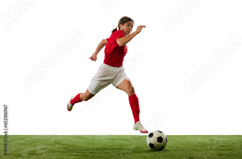 Dynamic image of young girl, football, soccer player in motion, dribbling ball isolated over white background