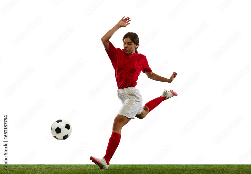 Dynamic image of young woman, football player in motion, kicking ball in jump isolated over white background