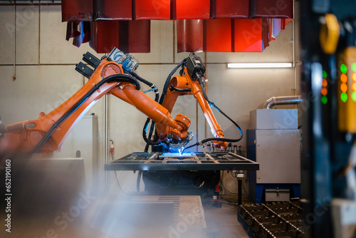Industrial robotic arms welding in factory photo