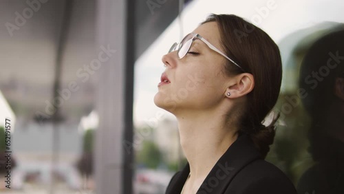 Macro close-up very tired woman leaning on wall and breathing, exhausted, fed up with gossip and discussions at work, bad team, emotional burnout