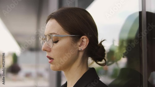 Upset young woman staying outdoor, deeply breathing trying to calm down, suffering sexual harassment at work, macro face close-up