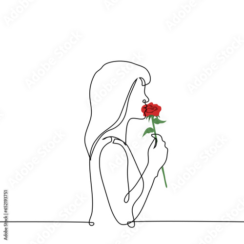 woman stands with a red rose pressed to her lips - one line art vector. concept woman is in love, love of flowers, metaphor of falling in love with an artificially created image
