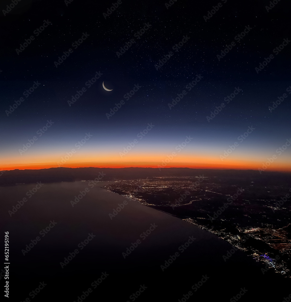 View of Antalya city and city lights from the plane at sunset - obrazy, fototapety, plakaty 