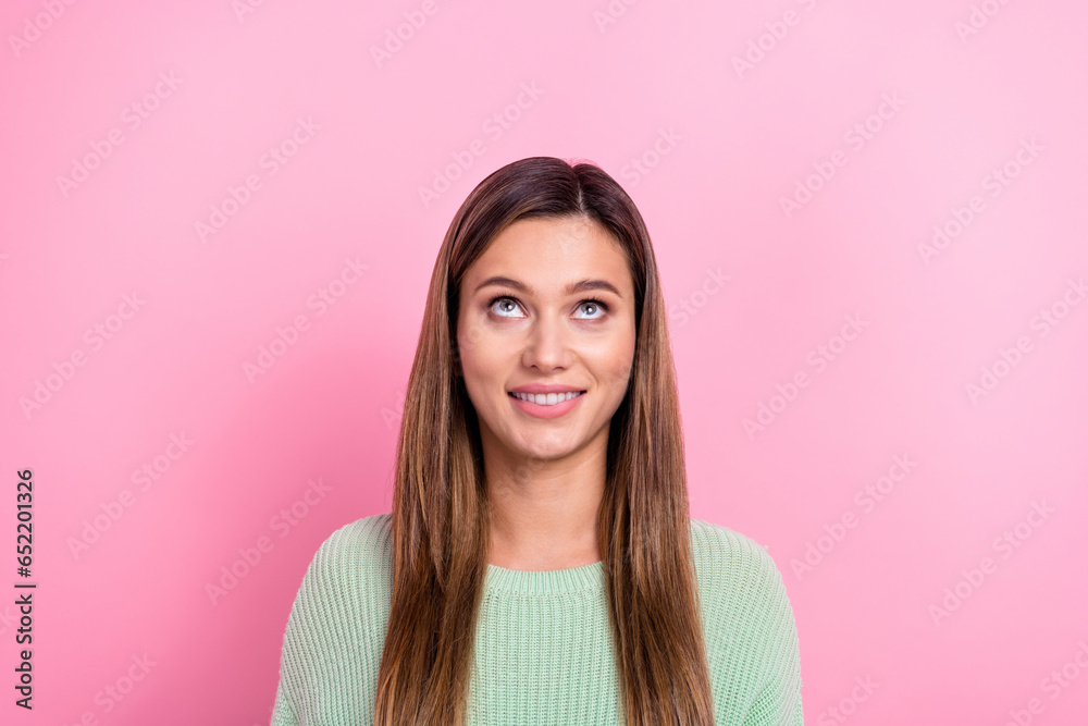 Portrait of interested young woman brown hair wear green sweater looking curious up above head dreams isolated on pink color background Portrait of interested young woman brown hair wear green sweater looking curious up above head dreams isolated on pink color background