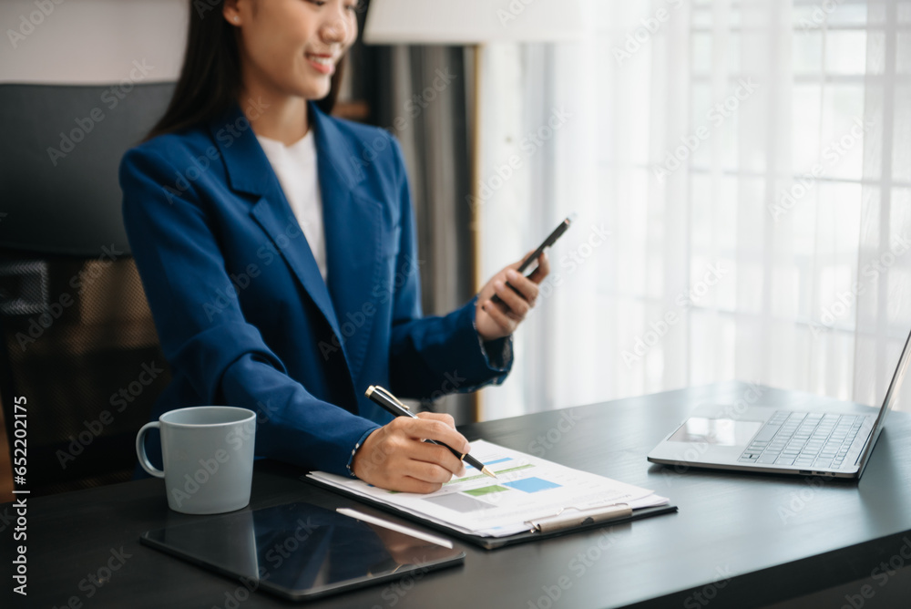 Woman freelancer is working her job on computer tablet and laptop Doing accounting analysis report real estate investment data, Financial Woman freelancer is working her job on computer tablet and laptop Doing accounting analysis report real estate investment data, Financial