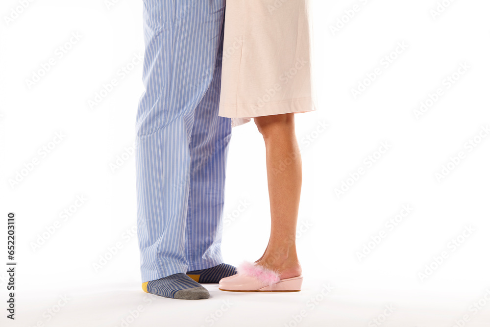 A couple in pajama. White background. Legs detail. Casual night wear