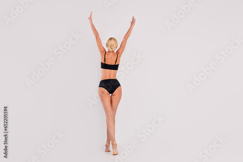 Full size back view photo of hands up beautiful woman comfortable feel girlish dreams come true diet done isolated on gray color background