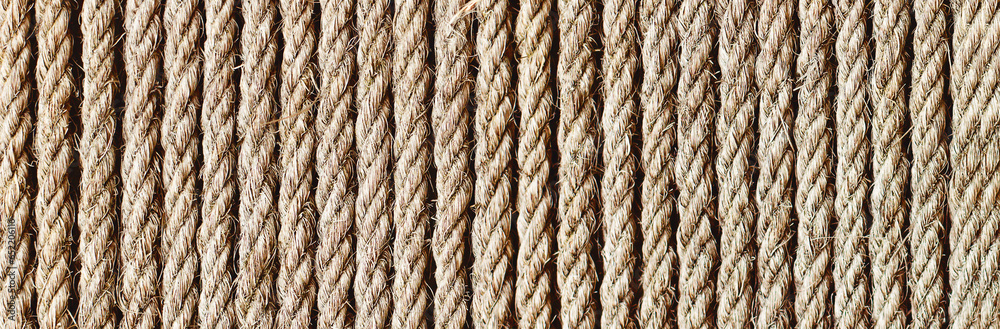 Rope texture. Brown old rope lines. Striped pattern. Retro textile texture. Stripes background on canvas. Twine pattern. Panoramic rope background. Website header design.