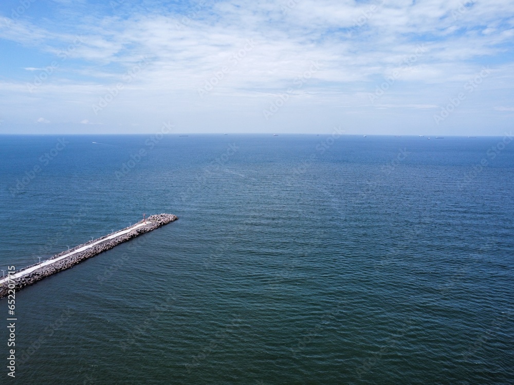 mezmerizing aerial drone shot of the sea and sky at daytime with a dock at the side in america mezmerizing aerial drone shot of the sea and sky at daytime with a dock at the side in america