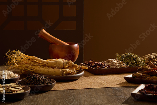 Obraz na plátně Front view of traditional herbs on wooden trays, mortar and pestle on wooden table background with traditional window frame