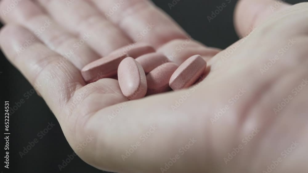 Holding medical pills on female hand Holding medical pills on female hand