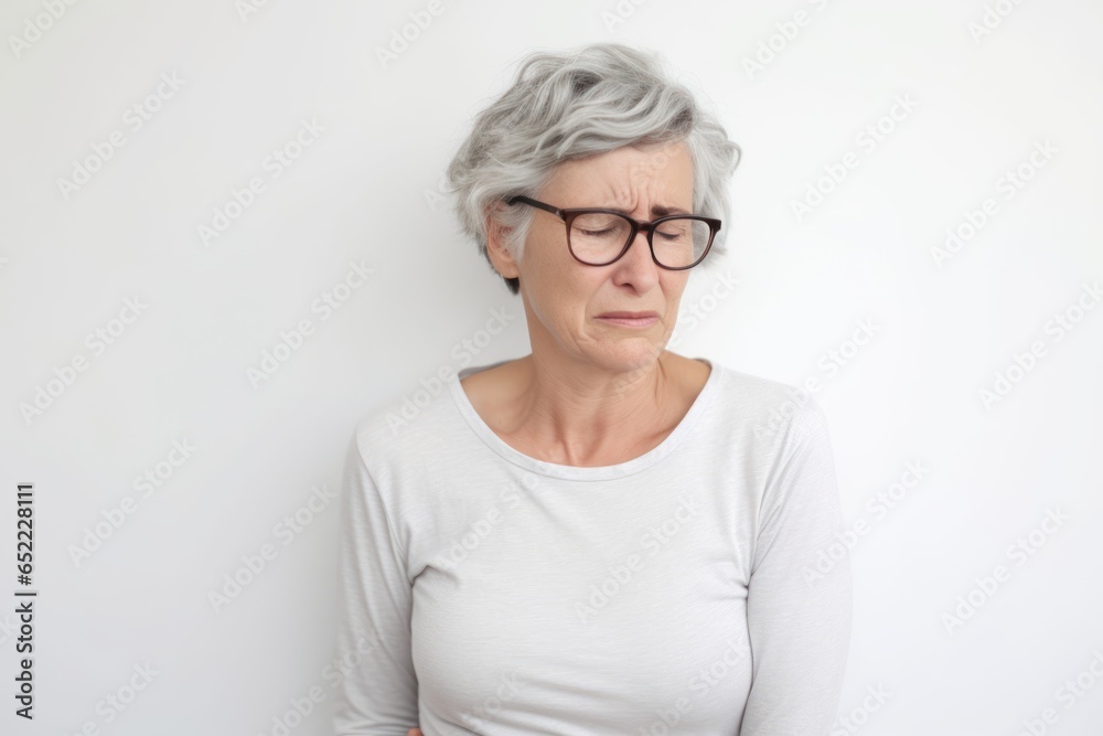 Mature woman with eyeglasses looking at camera over white background Mature woman with eyeglasses looking at camera over white background