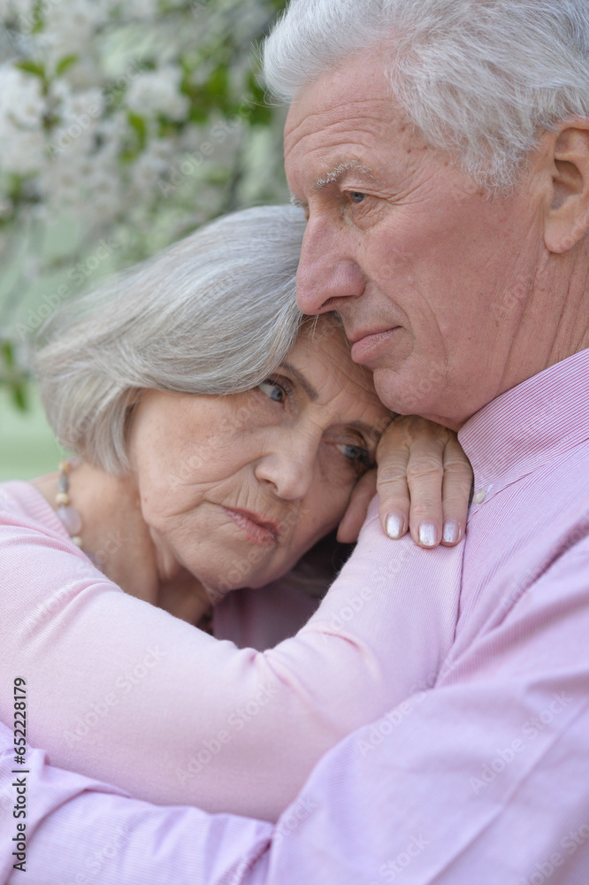 Portrait of sad senior couple in the park