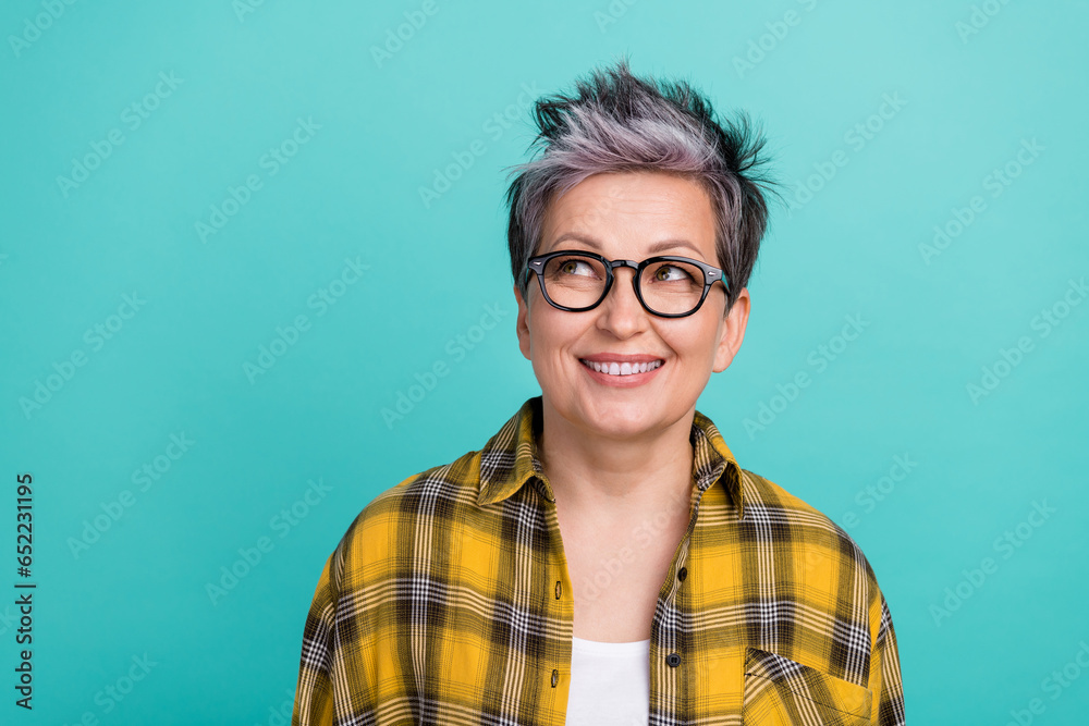 Photo portrait of lovely senior lady look empty space dressed stylish checkered yellow garment isolated on aquamarine color background