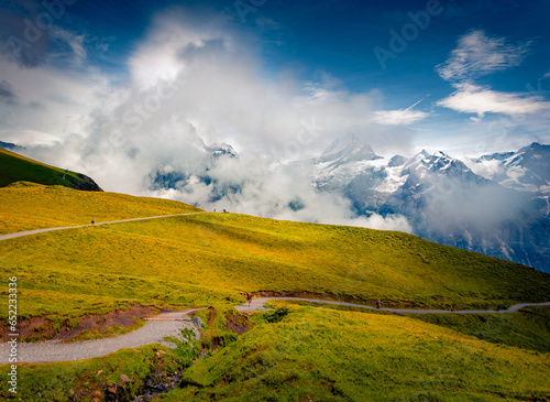 Foggy summer view of Schreckhorn peak. Traveling in Swiss Alps, Grindelwald village location, Switzerland, Europe. Beauty of nature concept background.