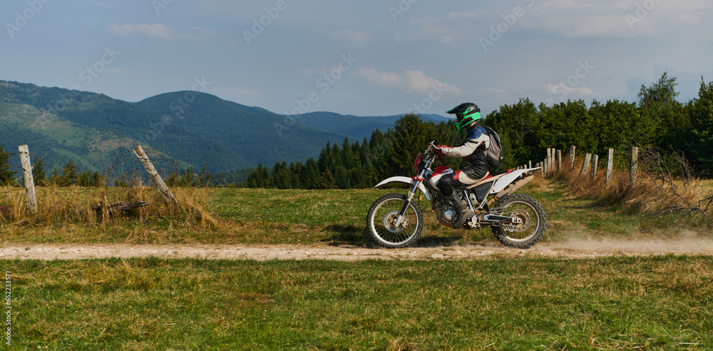 A professional motocross rider exhilaratingly riding a treacherous off-road forest trail on their motorcycle. A professional motocross rider exhilaratingly riding a treacherous off-road forest trail on their motorcycle.