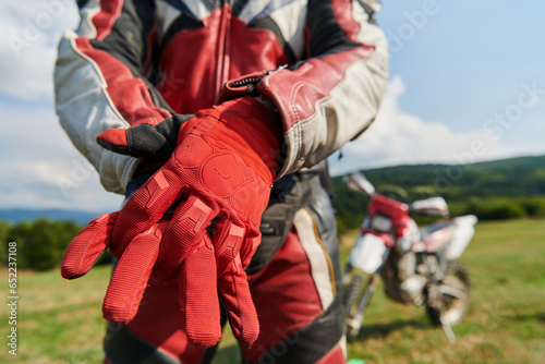 Tableau sur toile A professional motocross rider putting his gloves and preparing for a profession
