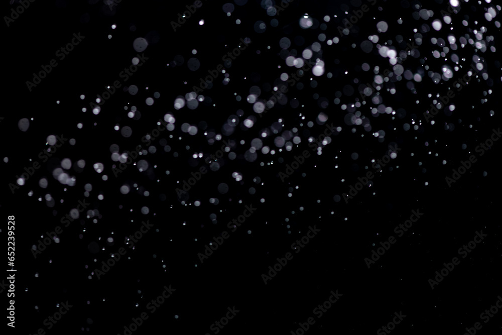 small drops of rain, snow on a black background. wind. Natural background