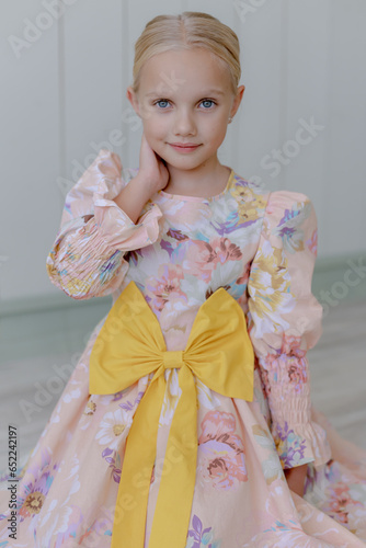 Beautiful portrait of a girl in a stylish dress. Looking into the camera.