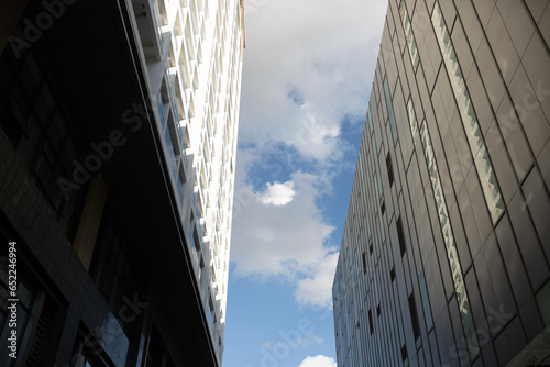 Low angle looking up at tall corporate glass building

