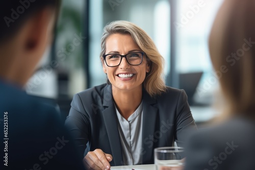 Mature business woman having a discussion with her team.