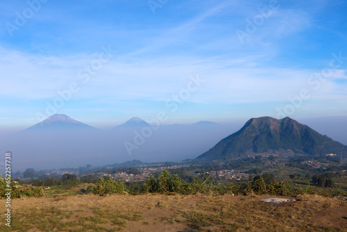 view of the peaks of several mountains at sunrise in the morning