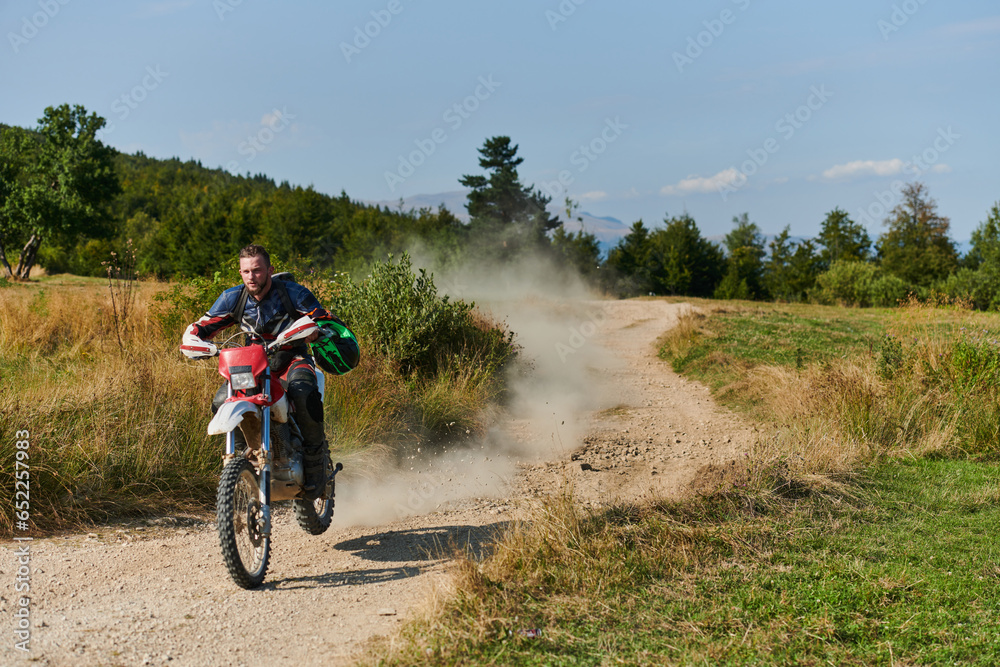 A professional motocross rider exhilaratingly riding a treacherous off-road forest trail on their motorcycle. A professional motocross rider exhilaratingly riding a treacherous off-road forest trail on their motorcycle.
