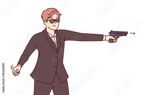 Man secret agent shoots gun, dressed in formal suit and sunglasses for covert operations. Secret agent guy works for special services or CIA, performing especially dangerous tasks national importance