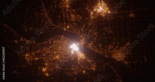 Peoria (Illinois, USA) aerial view at night. Top view on modern city with street lights. Camera is zooming out, rotating counterclockwise. Vertical video. The north is on the left side photo