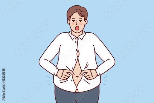 Fat man with big belly is trying to button up small shirt and is screaming in excitement at being overweight. Overweight guy needs help of nutritionist or fitness trainer to get rid of excess weight.