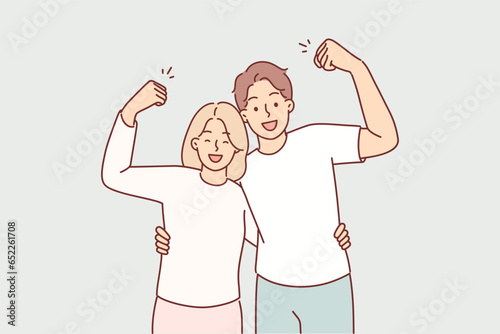 Strong couple shows biceps and hugs, saying together we are strong, thanks to married