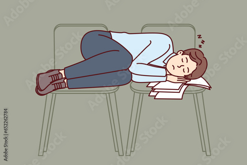 Business man sleeps on office chairs due to professional burnout and overwork that caused severe fatigue. Guy in business clothes sleeping at work after defaulting mortgage payment and losing home